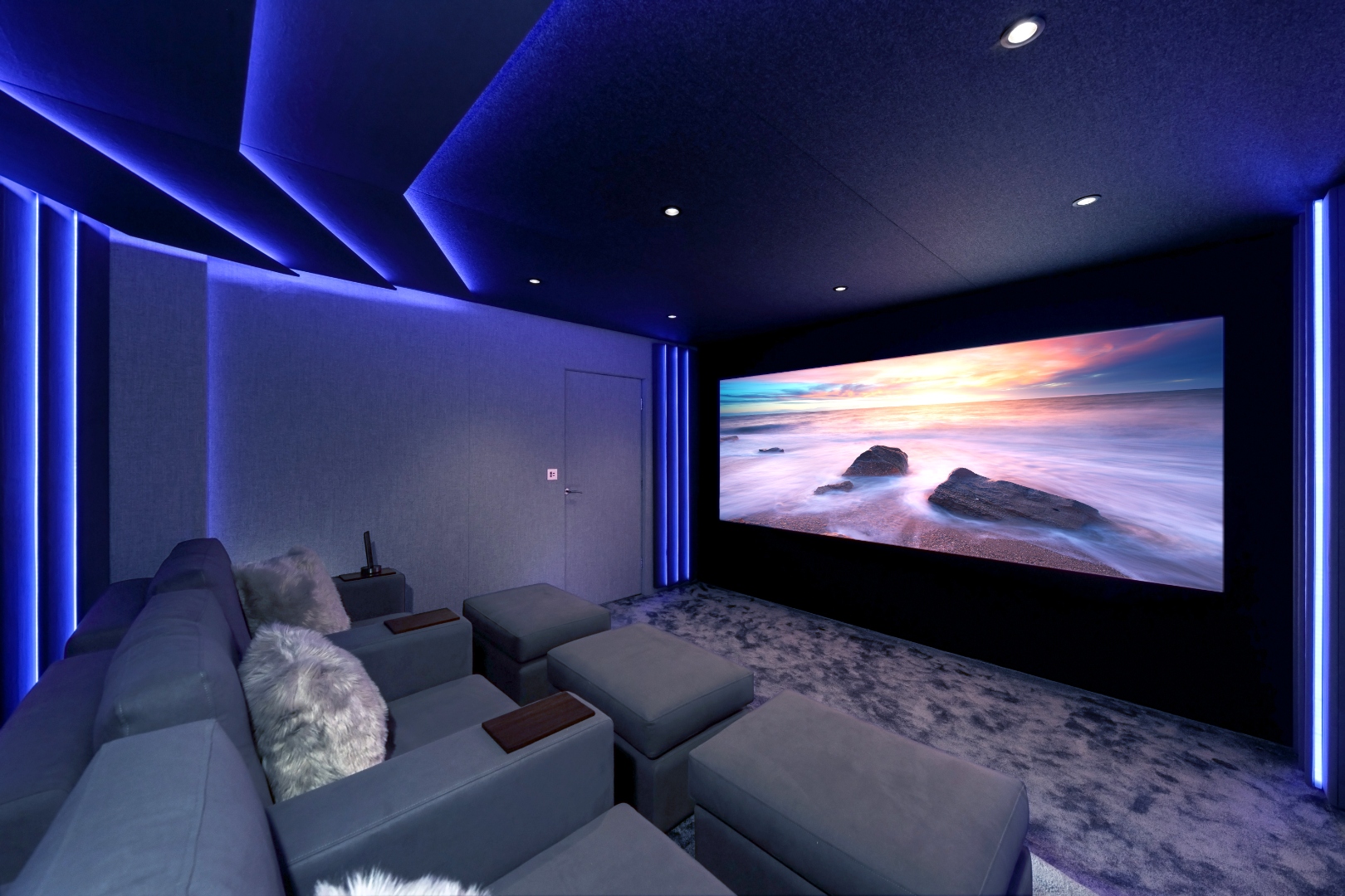 Cinema Lusso private cinema room with blue ambient LED lighting and widescreen projection