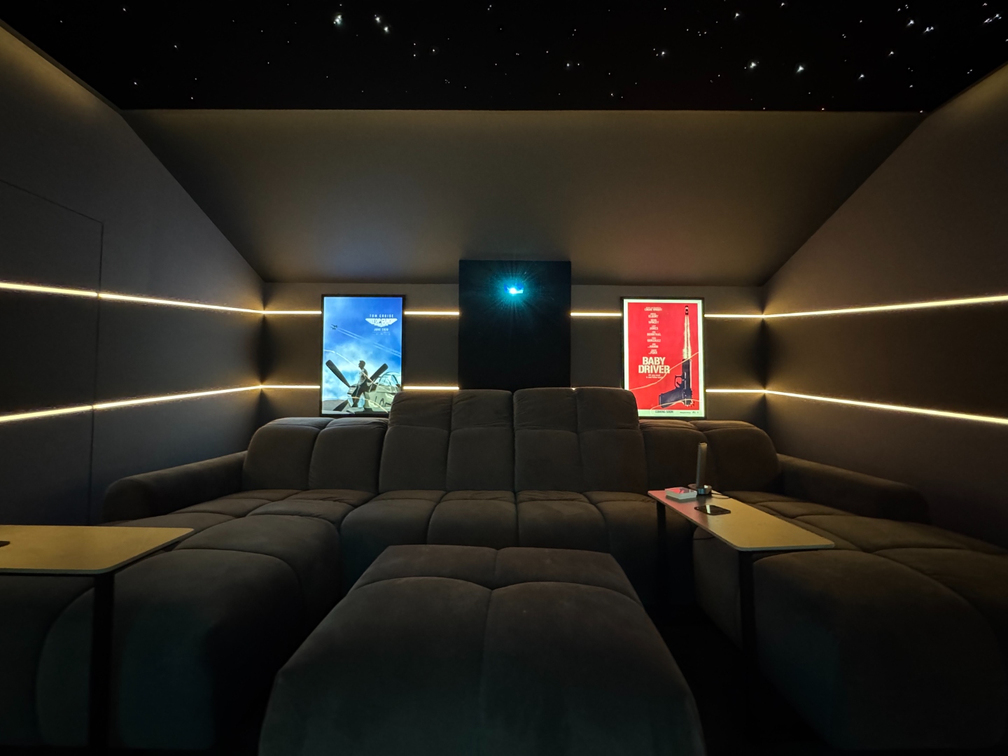 Cinema room rear view with star ceiling and film posters